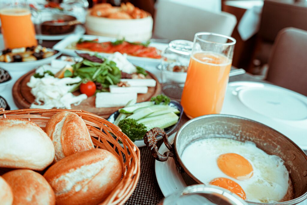 pexels-photo-2662875-2662875-3 Appetizing breakfast table with orange juice, fried eggs, breads, and fresh vegetables.